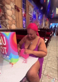 a woman sits at a table with a sign that says i love you