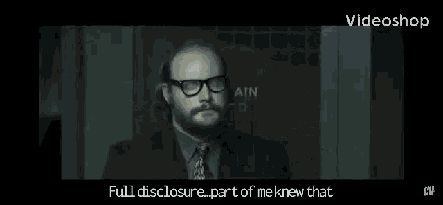 a man in a batman costume is standing in front of a sign that says " full disclosure "
