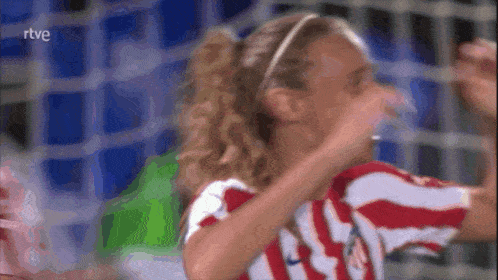 a woman in a red and white striped shirt with the number 19 on her shirt