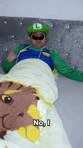 a man dressed as luigi is laying in bed