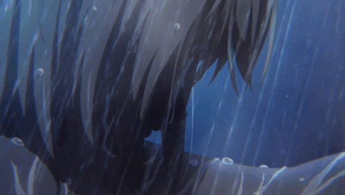 a close up of a person in the water with bubbles coming out of their hair