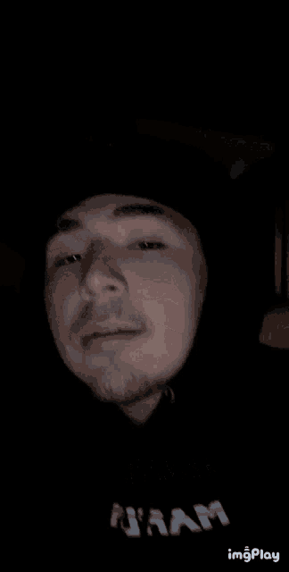 a man without a shirt is making a funny face in a dark room with the words imgplay at the bottom