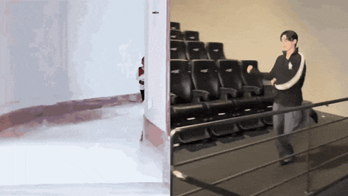 a man is standing in front of a row of black seats in a theater