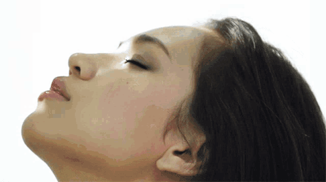 a woman 's face is shown with her eyes closed