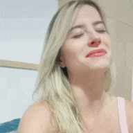 a woman is making a funny face with her mouth open .