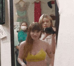 a woman is taking a picture of herself in a mirror