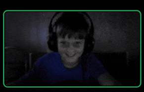 a boy wearing headphones and a blue shirt is smiling