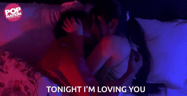 a man and woman kissing on a bed with the words tonight i 'm loving you below them