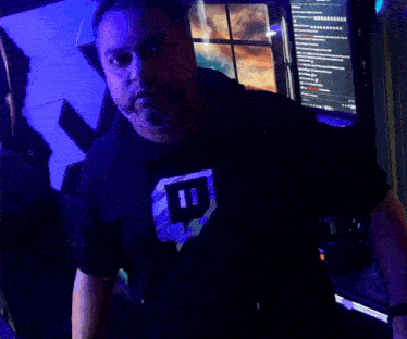 a man wearing a black t-shirt with the letter i on it