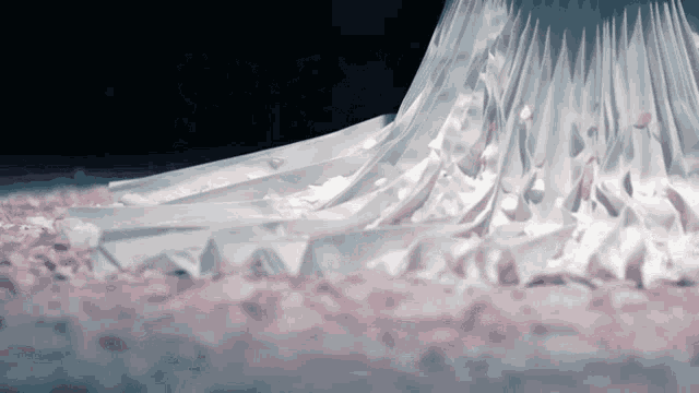 a woman in a long white dress is surrounded by petals