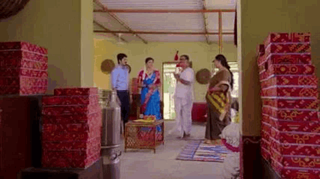 a group of people are standing in a room surrounded by boxes .
