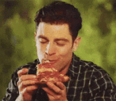 a man in a plaid shirt is eating a slice of pizza