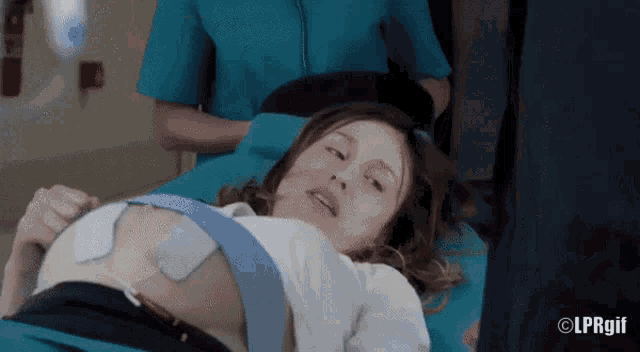 a pregnant woman is laying on a hospital bed with lprgif written on the bottom of the image