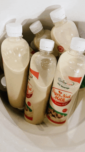 several bottles of figen nut milk are in a container