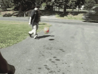 a ups van is parked on the side of the road behind a man holding a basketball