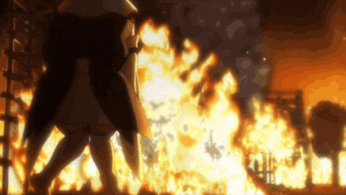 a person is standing in front of a fire