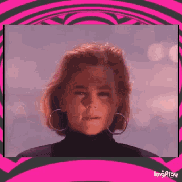 a woman wearing a black turtleneck and hoop earrings is looking at the camera .