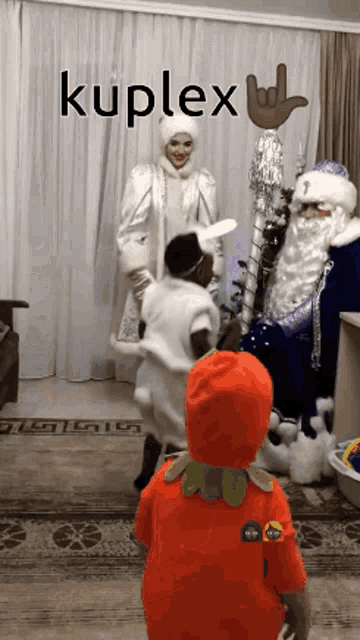 a kid in an orange pumpkin costume stands in front of a sign that says kuplex on it