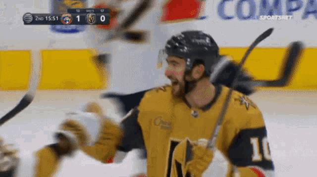 a hockey player with the number 10 on his jersey is celebrating