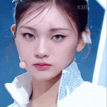 a close up of a woman 's face with kbs on the bottom right