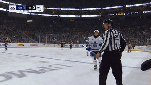 a hockey game is being played and the score is 1 to 0