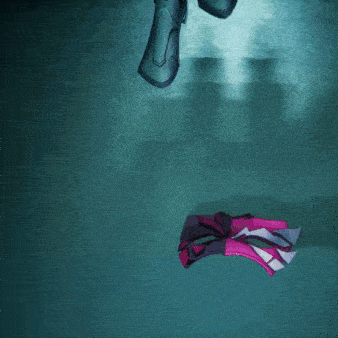 a person is reaching out towards a purple object