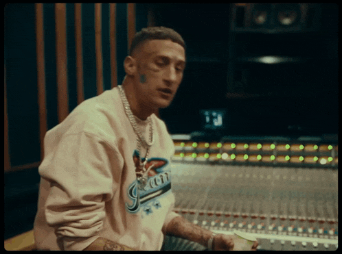 a man wearing a sweater that says miami on it