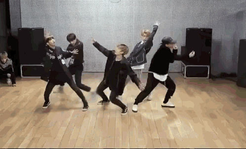 a group of young men are dancing together in a dance studio .