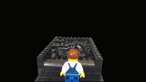 a lego figure stands in front of a pile of bricks