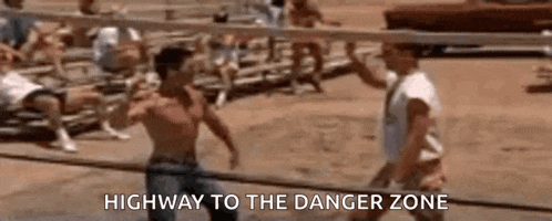 two men are playing volleyball on a beach and one of them is talking to the other .