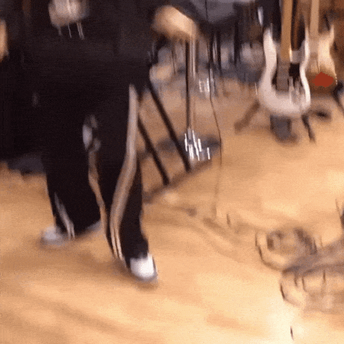 a person 's feet are shown in a blurry photo while playing a guitar