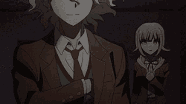 a man in a suit is holding a gun next to a girl