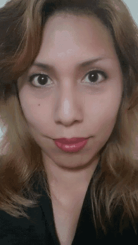 a woman with blonde hair is wearing red lipstick