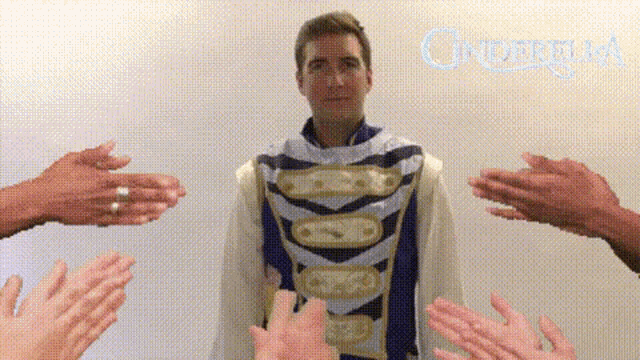 a man in a cinderella outfit is surrounded by people clapping