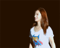 a woman wearing a white t-shirt with a picture of a cat on it