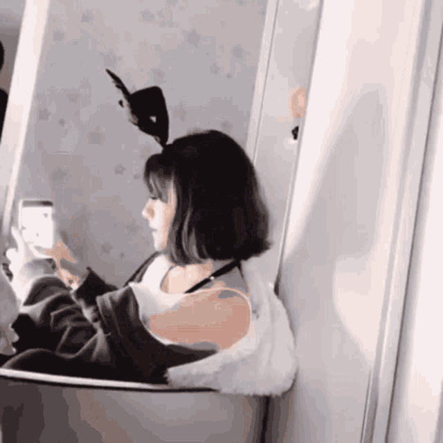 a woman is taking a picture of herself in the mirror