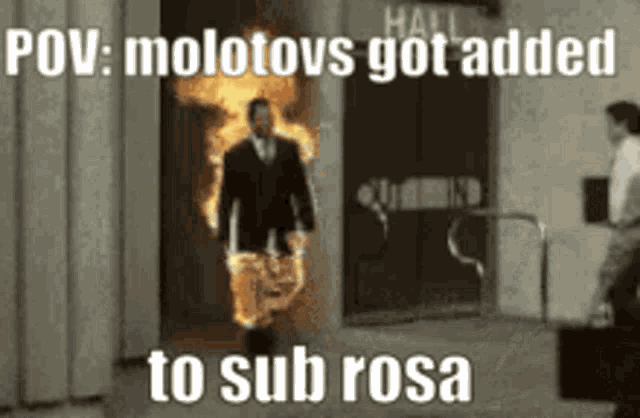 a man in a suit is walking out of a building with a fire coming out of it .