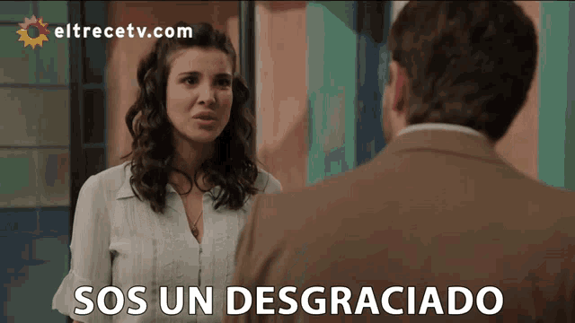 a woman talking to a man with the words sos un desgraciado