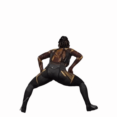 a woman in a black and gold costume is standing on her knees