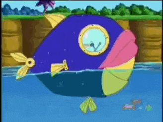a colorful fish is swimming in the water with a cliff in the background
