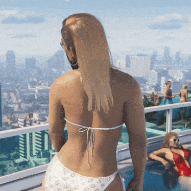 a woman in a bikini stands on a balcony overlooking a pool