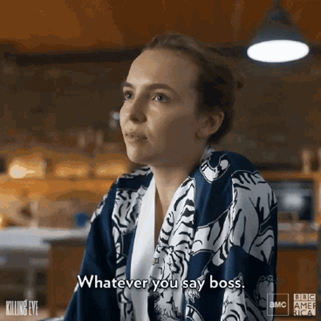 a woman in a blue and white robe is saying whatever you say boss .