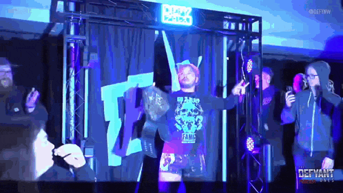 a man in a fame shirt is walking through a ring
