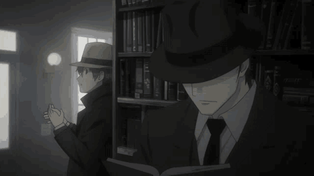 a man in a hat reads a book in front of a bookshelf