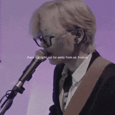 a man singing into a microphone with a quote that says there is a light not far away from us from us