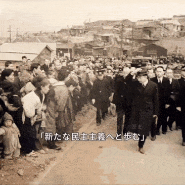 a black and white photo of a group of people with foreign writing