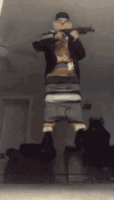 a person is dancing in a living room with a ceiling fan