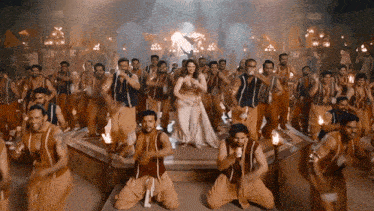 a woman in a white dress is surrounded by men