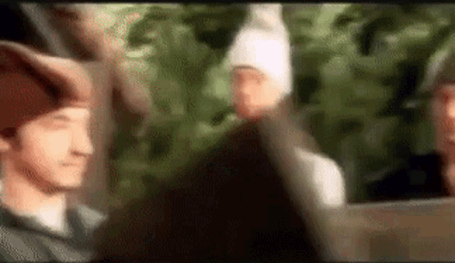a blurry picture of a group of people wearing beanies .