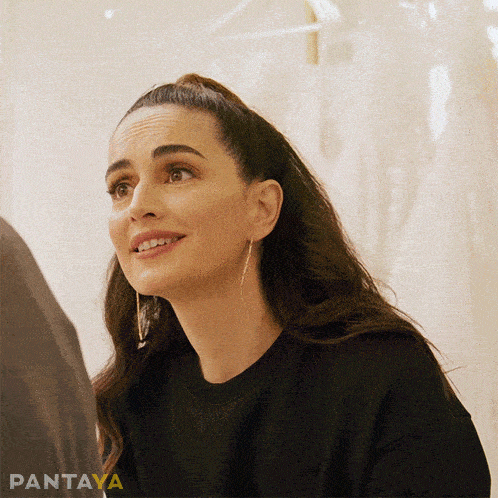 a woman wearing a black sweatshirt with pantaya written in yellow